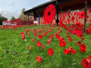 Our community wreath installation outside Hunsbury Library, created by volunteers. This year poppies and faith symbols were laid by pupils from East Hunsbury Primary, Simon de Senlis Primary, and Wootton Park School, and by members of 50th Hunsbury Scouts.